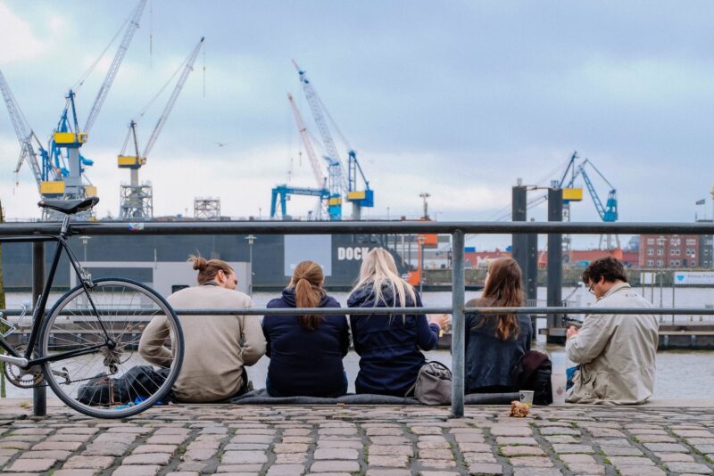 Early morning revellers enjoy a beer and fish sandwich on the banks of the elbe at Hamburg's fischmarkt