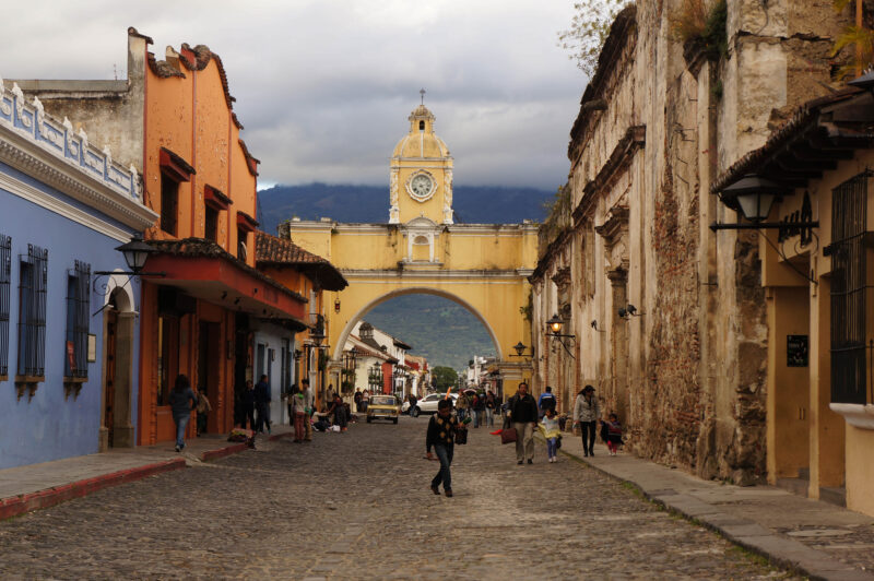 A street scene in Antigua, Guatemala with the famous archway