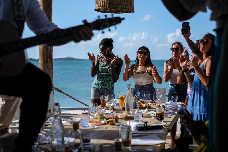 People dancing to musicians at The Hut, Little Jumby in Antigua and Barbuda